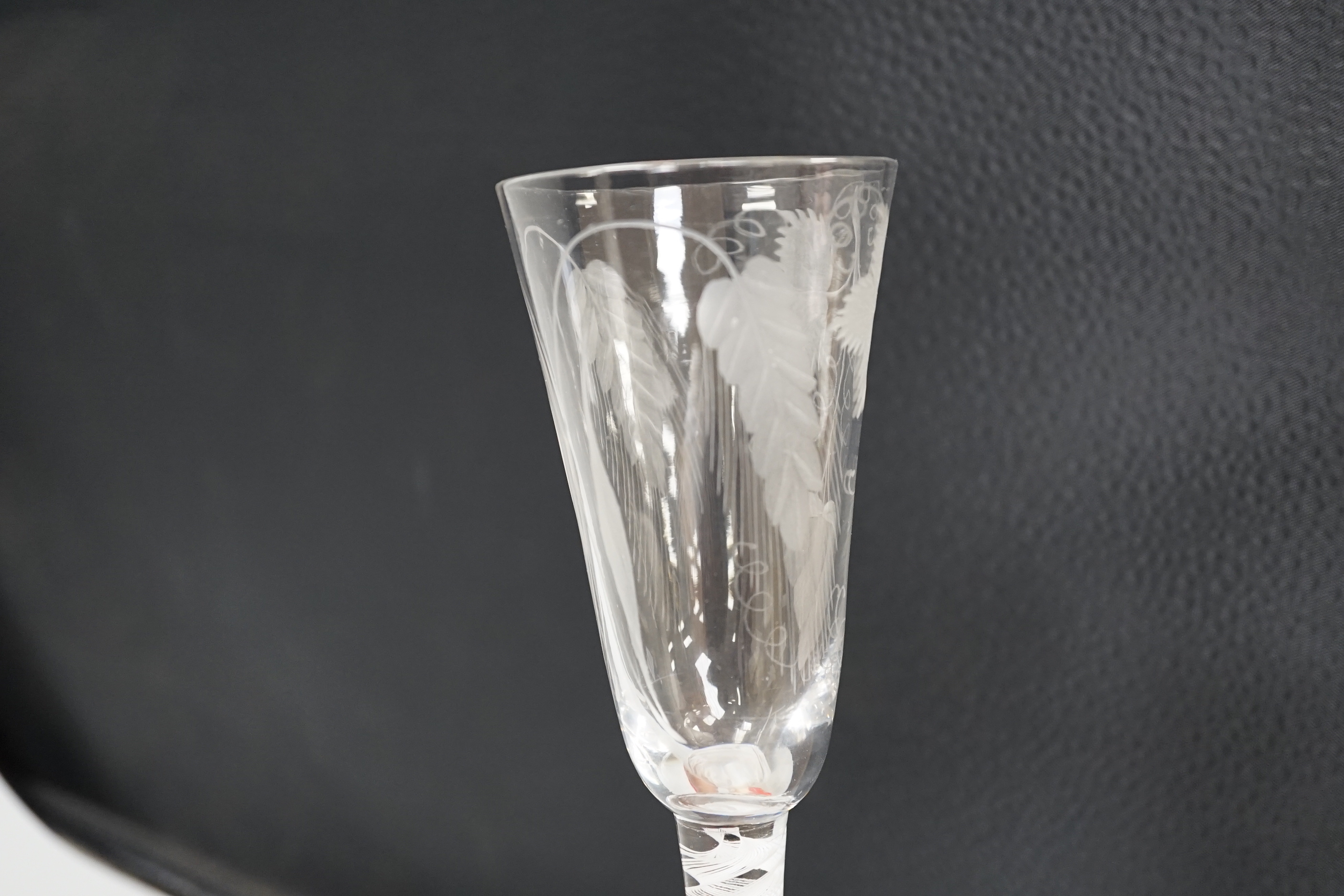 An English lead crystal SSOT ale glass, c.1760, the elongated round funnel bowl engraved with hops and barley, the stem with a rare SSOT scrambled eighteen ply spiral band, conical foot, snapped pontil, tool marked and s